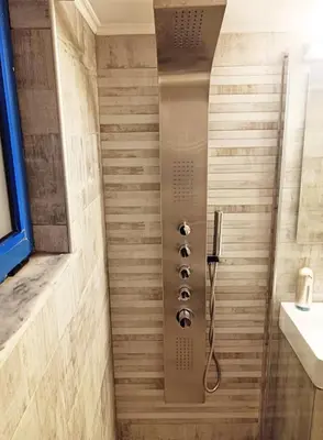 a shower with a shower head in a bathroom at Kafkales Penthouse Chania Old Town in Chania Town