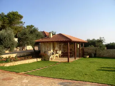 a small house with a gazebo in a yard at Dream Hill Villas in Tavronitis