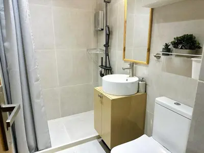 a bathroom with a toilet and a sink and a shower at Nomas Home, Kalyves Centre Beachfront Sea View in Kalyves