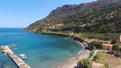 a view of a beach with boats in the water at To Petrino Stone Mountain Retreat with Private Pool in Rodhopós