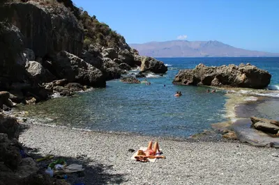 a group of people laying on a rocky beach at To Petrino Stone Mountain Retreat with Private Pool in Rodhopós