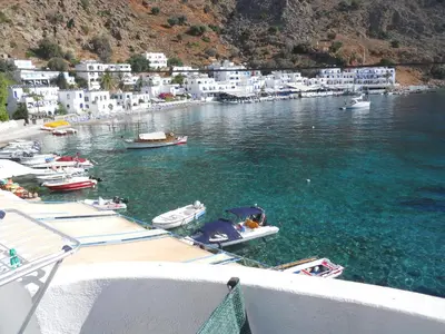 a group of boats are docked in a harbor at Daskalogiannis Hotel in Loutro