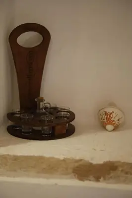 a clock sitting on top of a shelf with a vase at SternesVillage, Middle Ground Floor in Stérnai
