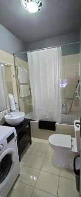 a bathroom with a washing machine and a sink at Aphrodite villa in Darmarochori
