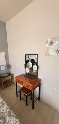 a table with plates on it next to a wall at Aphrodite villa in Darmarochori