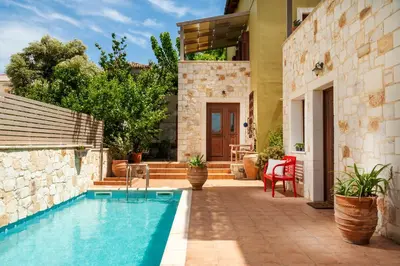 a house with a swimming pool in a yard at Villa Eftichia in Stalos