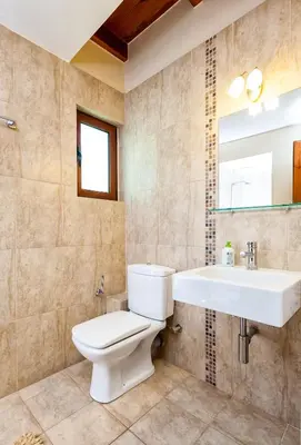 a bathroom with a toilet and a sink at Villa Eftichia in Stalos