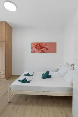 a bed in a white room with at Cozy Apartment Next To The Beach In Almyrida -BY APOKORONAS VILLAS in Almirida