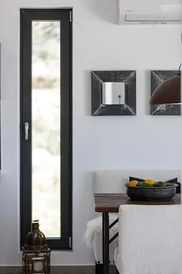 a dining room with a table and a mirror at Villa EsHi w Private Pool & Scenic Sea View in Kalyves