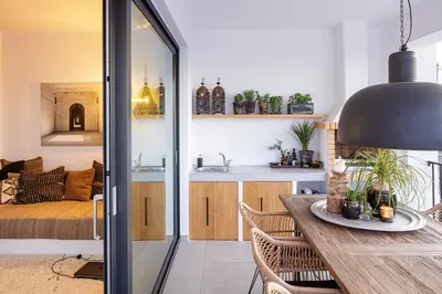 a kitchen and living room with a table and chairs at Villa EsHi w Private Pool & Scenic Sea View in Kalyves