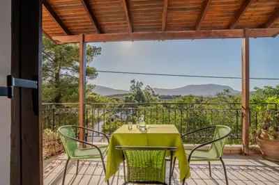 a table and chairs on a balcony with a view at Traditional Art House Armenoi in Arménoi
