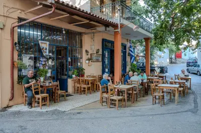 a group of people sitting at tables outside a restaurant at Traditional Art House Armenoi in Arménoi