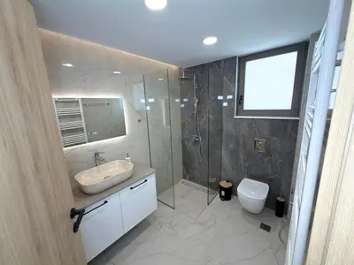 a bathroom with a sink and a shower and a toilet at Cozy Suite Palaiochora Sea View, Jacuzzi, Top WiFi in Palaiochóra