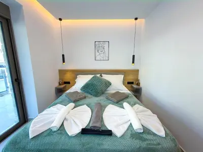 a bedroom with a bed with two wings on it at Cozy Suite Palaiochora Sea View, Jacuzzi, Top WiFi in Palaiochóra