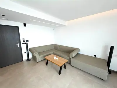 a living room with a couch and a coffee table at Cozy Suite Palaiochora Sea View, Jacuzzi, Top WiFi in Palaiochóra