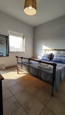 a bedroom with a large bed in a room at John's TownHouse Chania in Tsikalariá