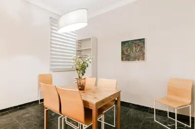 a dining room with a wooden table and chairs at Leda's Nea Chora Flat, Near Beach and Old Port in Chania Town