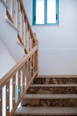a wooden staircase with a door and a window at KHORA Apartment- 40m to Sandy Beach in Chania Town