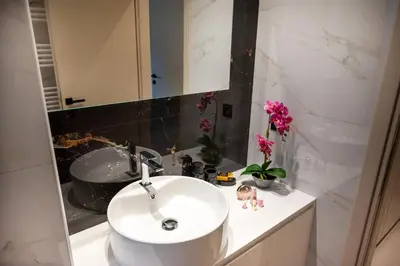a bathroom with a white sink and a mirror at Mystrali I in Galatás
