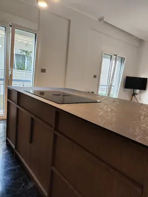 a kitchen with a large counter top in a room at Apartment Near Beach & Old Port in Chania Town