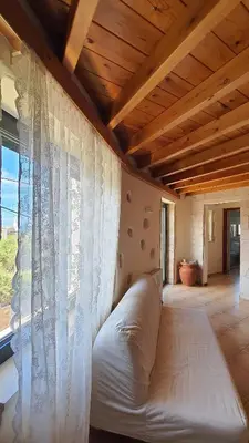 a white couch in a room with a window at Despoinas House in Kounoupidhianá