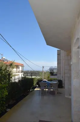 a patio with a table and chairs and a building at Despoinas House in Kounoupidhianá