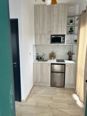 a kitchen with a sink and a microwave at Azure Sea Bliss at The Erodios Apartments in Kalyves