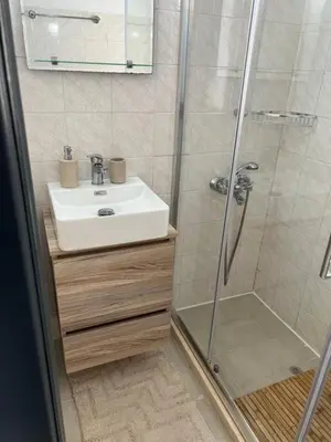 a bathroom with a sink and a shower at Azure Sea Bliss at The Erodios Apartments in Kalyves