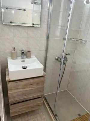 a bathroom with a sink and a shower at Azure Sea Bliss at The Erodios Apartments in Kalyves