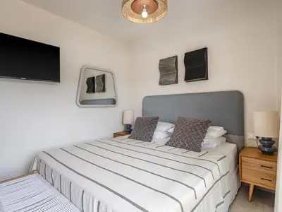 a bedroom with a bed and a flat screen tv at Iris Luxury Apartment in Chania Town