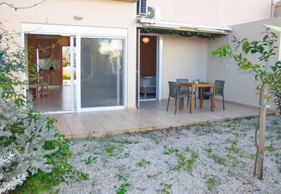 a patio with a table and chairs on it at Peris #2 - Souda in Souda