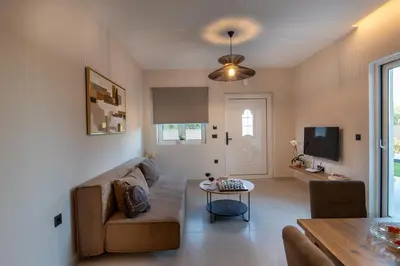 a living room with a couch and a table at Mystrali II in Galatás