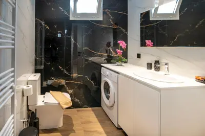 a bathroom with a washing machine and a sink at Mystrali II in Galatás