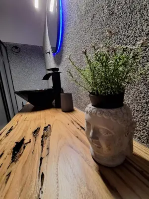 a vase with a plant on top of a table at Sea & City - Luxury Maisonette Steps from the Beach with Private Terrace in Chania Town