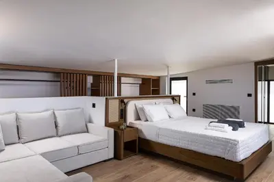 a bedroom with a large bed and a couch at Orus Villa in Chania Town