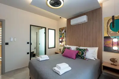 a bedroom with a bed with two towels on it at Golden Silence in Plataniás