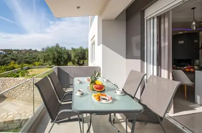 a table with a bowl of fruit on a balcony at Adriana Horizon Villa, Pool & Hillside View in Galatás