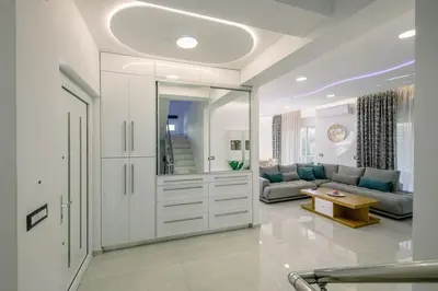 a living room with a couch and a mirror at Adriana Horizon Villa, Pool & Hillside View in Galatás