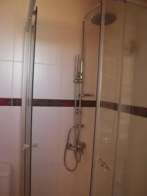 a shower with a glass door in a bathroom at Villa Santouraki in Keramotí