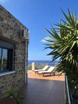 a patio with a view of the ocean from a house at Villa Santouraki in Keramotí
