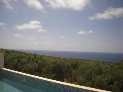 a swimming pool with a view of the ocean at Villa Santouraki in Keramotí