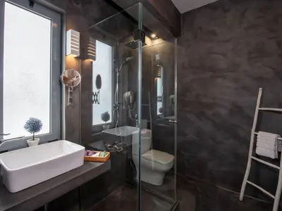 a bathroom with a sink and a toilet and a glass shower at Holiday Home Villa vacanze Agave Creta con piscina privata by Interhome in Litsárdha