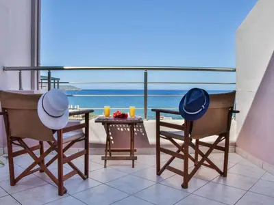 a table and chairs with a view of the ocean at Apartment Charmante Ferienwohnung Rubini 2 by Interhome in Agia Marina Nea Kydonias