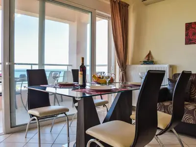 a dining room with a glass table and chairs at Apartment Charmante Ferienwohnung Rubini 2 by Interhome in Agia Marina Nea Kydonias
