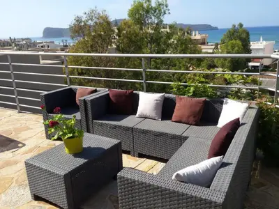 a patio with two couches and a table with a plant at Apartment Moderne Wohnung Rubini 3 by Interhome in Chania Town