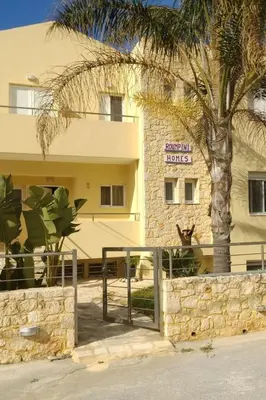 a hotel with a palm tree in front of a building at Apartment Moderne Wohnung Rubini 3 by Interhome in Chania Town