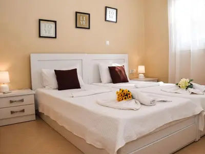 two beds in a bedroom with flowers on them at Apartment Rubini 1 by Interhome in Agia Marina Nea Kydonias