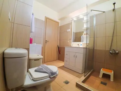 a bathroom with a shower and a toilet and a sink at Apartment Gemütliche Ferienwohnung Rubini 4 by Interhome in Agia Marina Nea Kydonias