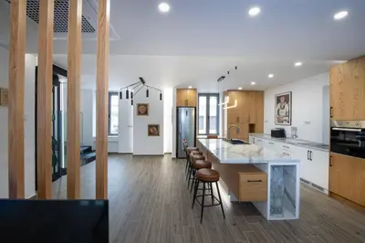a kitchen with a large island and bar stools at Chania Luxury City Retreat , Hammam & outdoor Jacuzzi in Chania Town