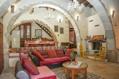 a living room with a couch and a table at Stone-Built Traditional Villa with Pool in Sfakia in Ímbros